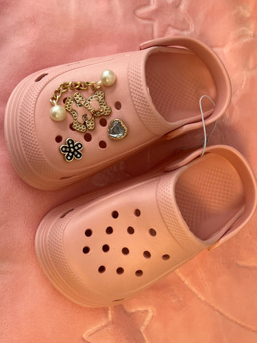 Pink crocs with charms